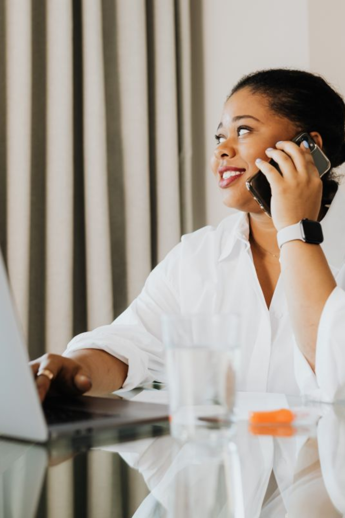 Woman talking on the phone smiling.