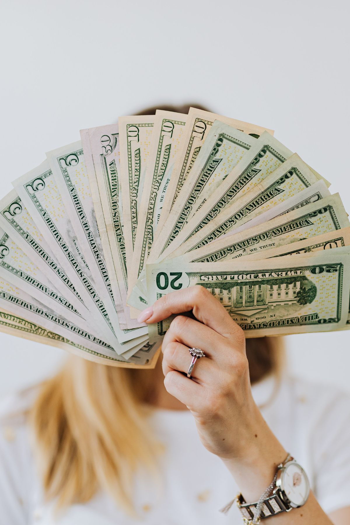 A woman fanning money out.