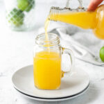 Pineapple apple cider vinegar shot being poured.