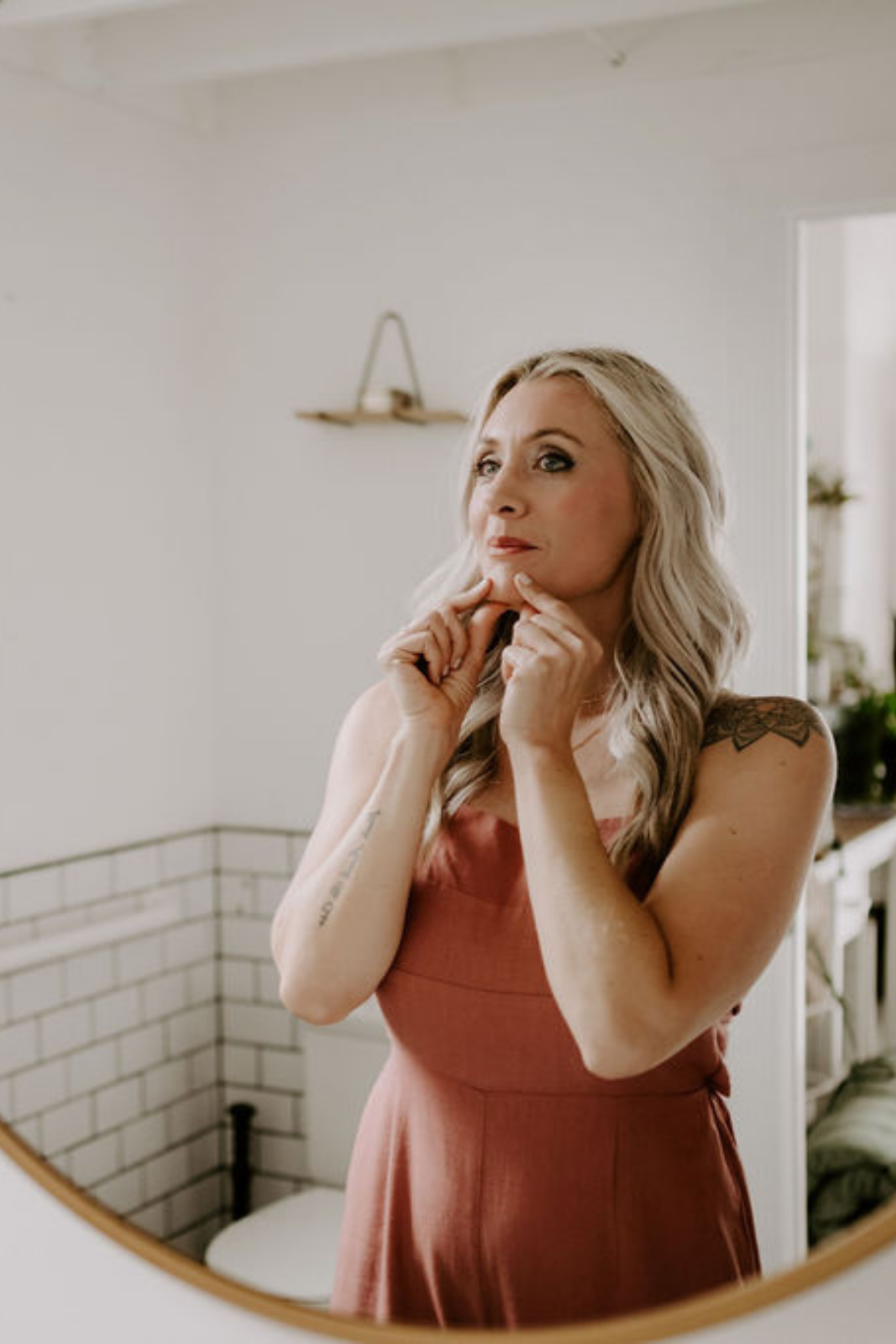 Loren Runion doing face yoga for chin in a mirror