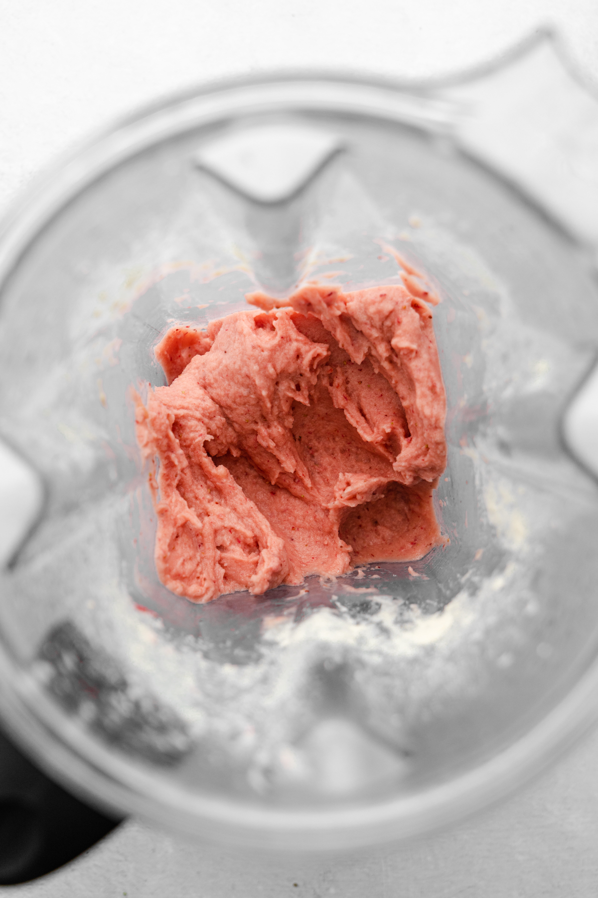 Strawberry mango smoothie bowl in blender after blending.