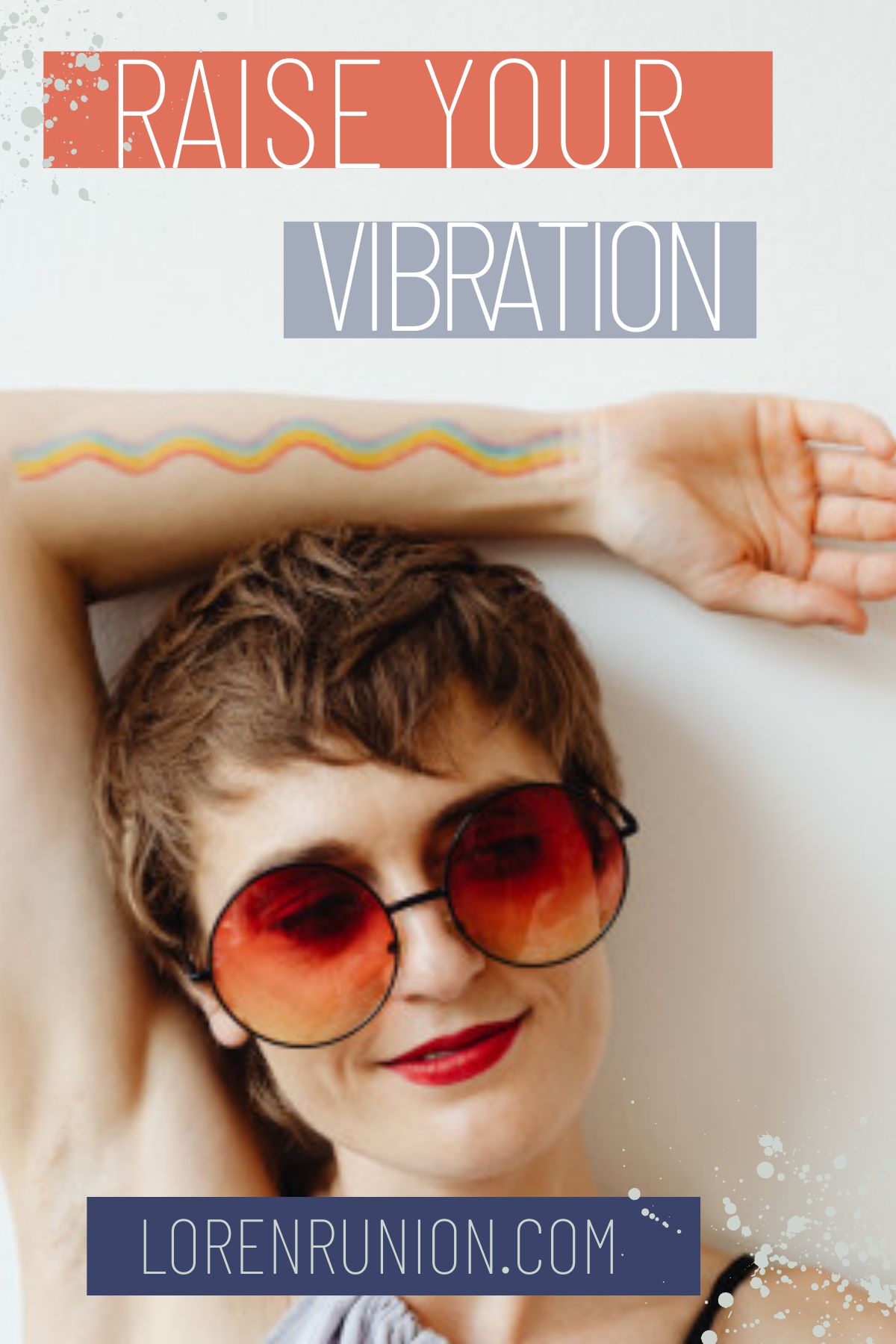 A woman with sunglass and a rainbow drawn on her arm.