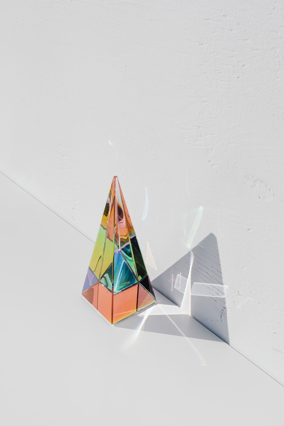 A prism on a white floor with a white background.