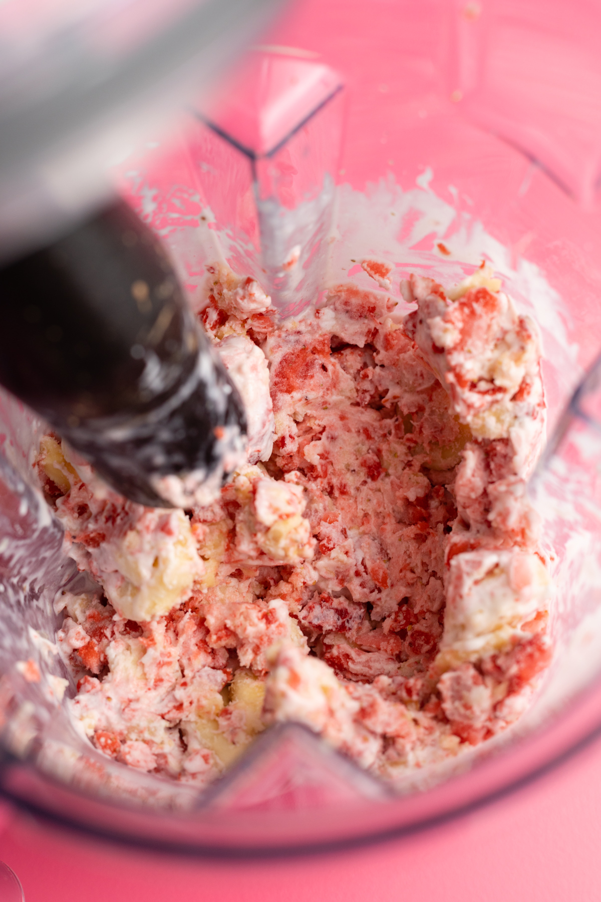 Halfway through blending using tamper for smoothie bowl.