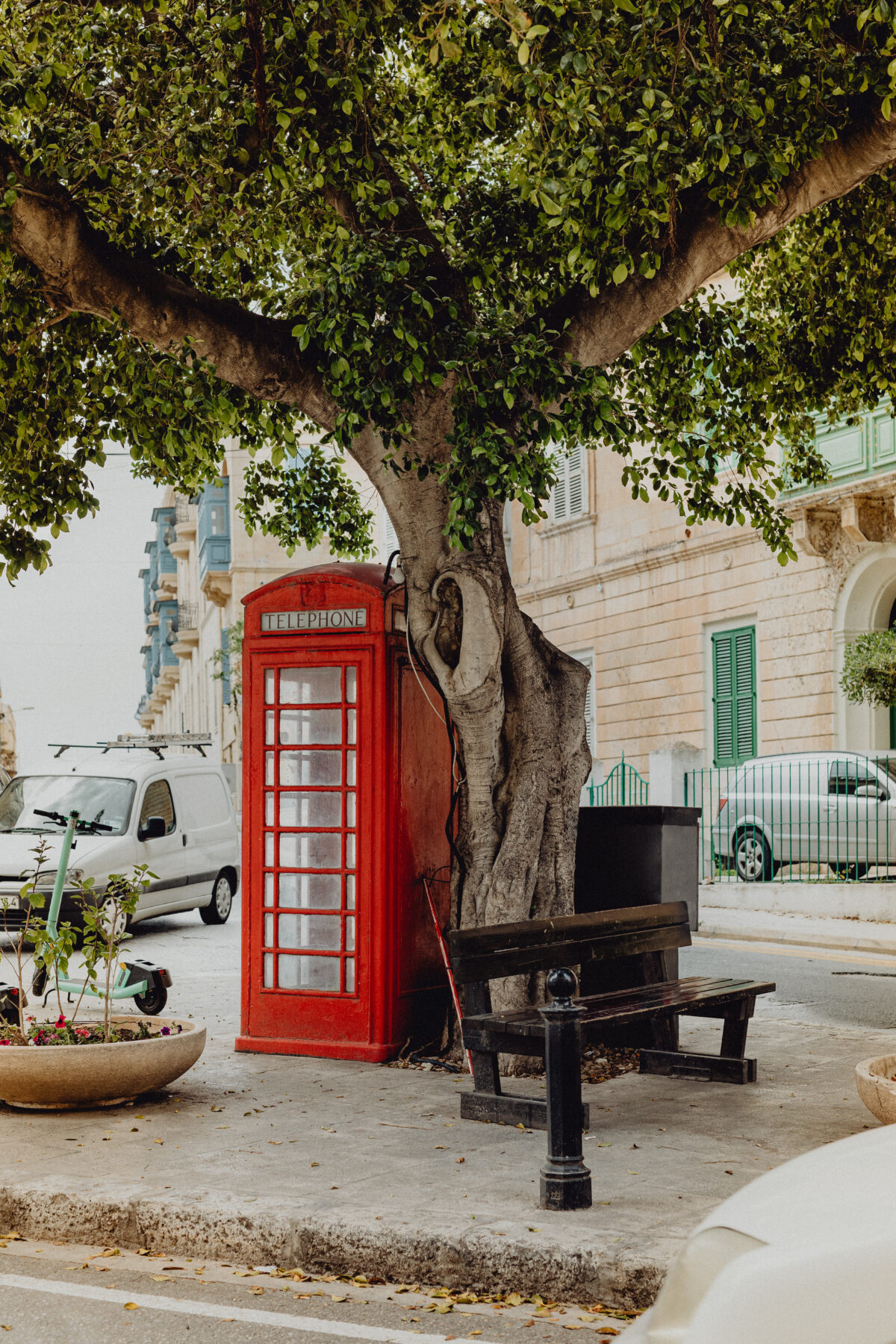 British red phone booth in a park.